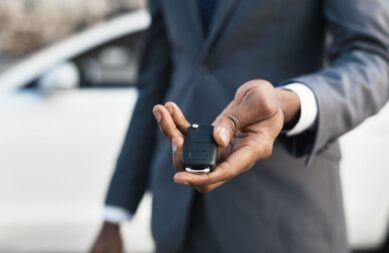car-sale-concept-man-hand-giving-car-key